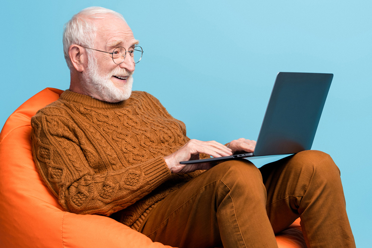 Older man typing on computer