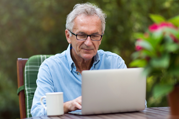 senior man researching on laptop computer