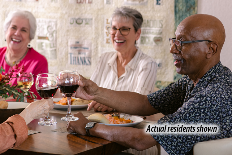 Holly Creek residents laughing and toasting with wine