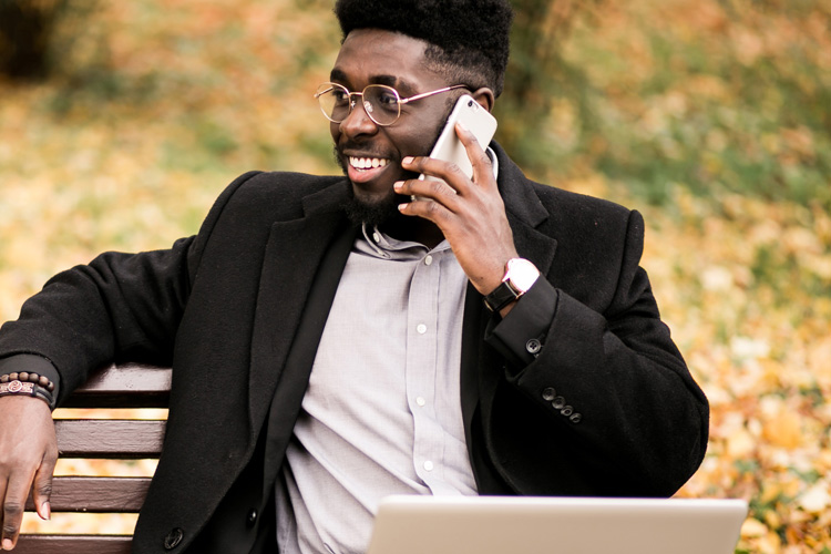 cdms man on phone with laptop