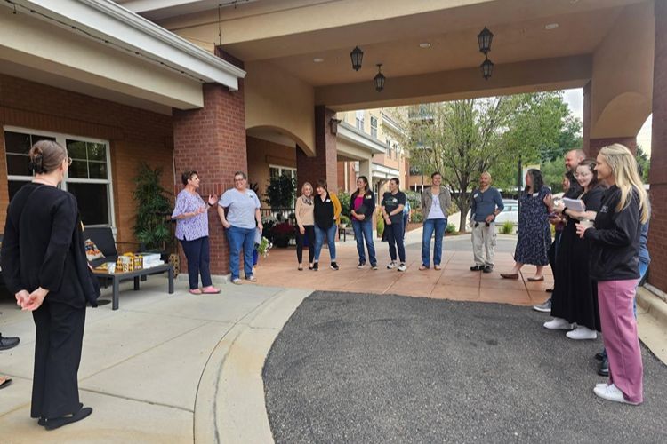 residents and team members gathering at the suites at clermont park patio